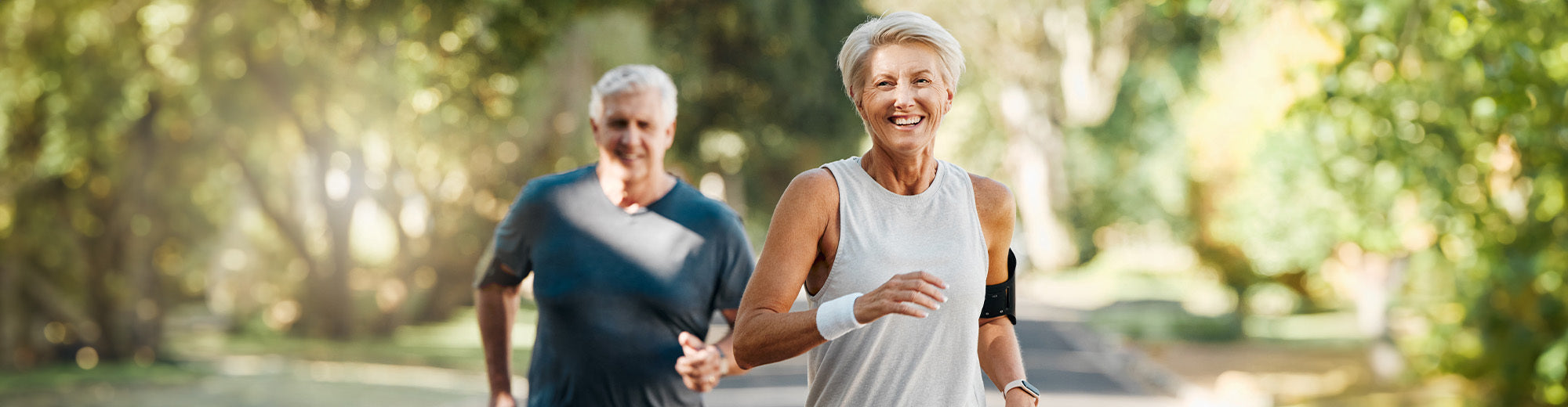 An older couple enjoying a run outdoors.